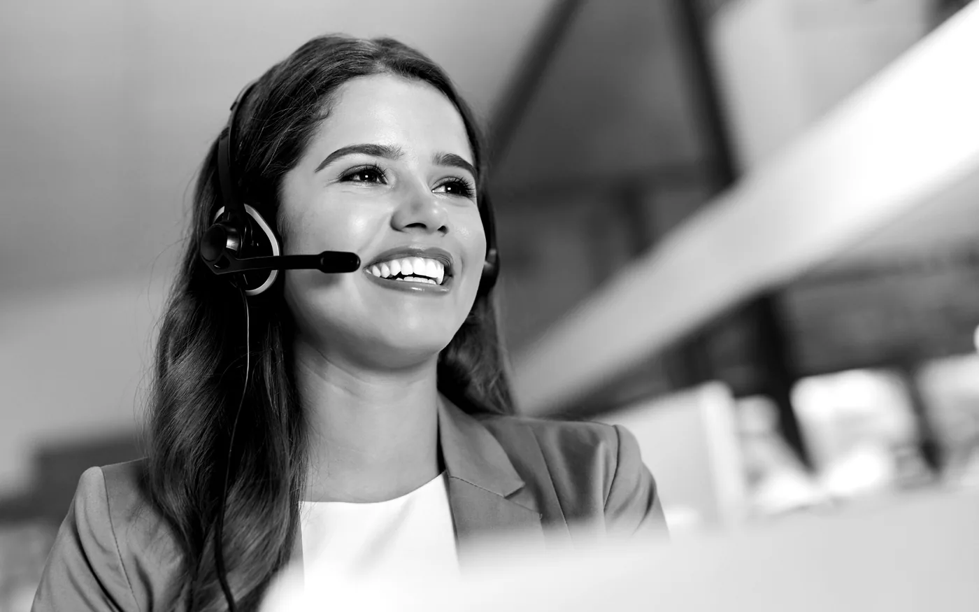 Black-and-white headset support specialist smiling