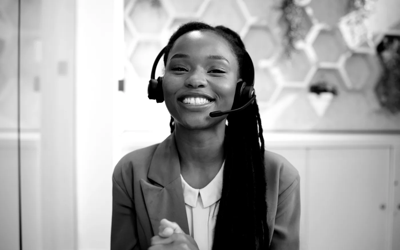 Black-and-white virtual assistant smiling during a video call