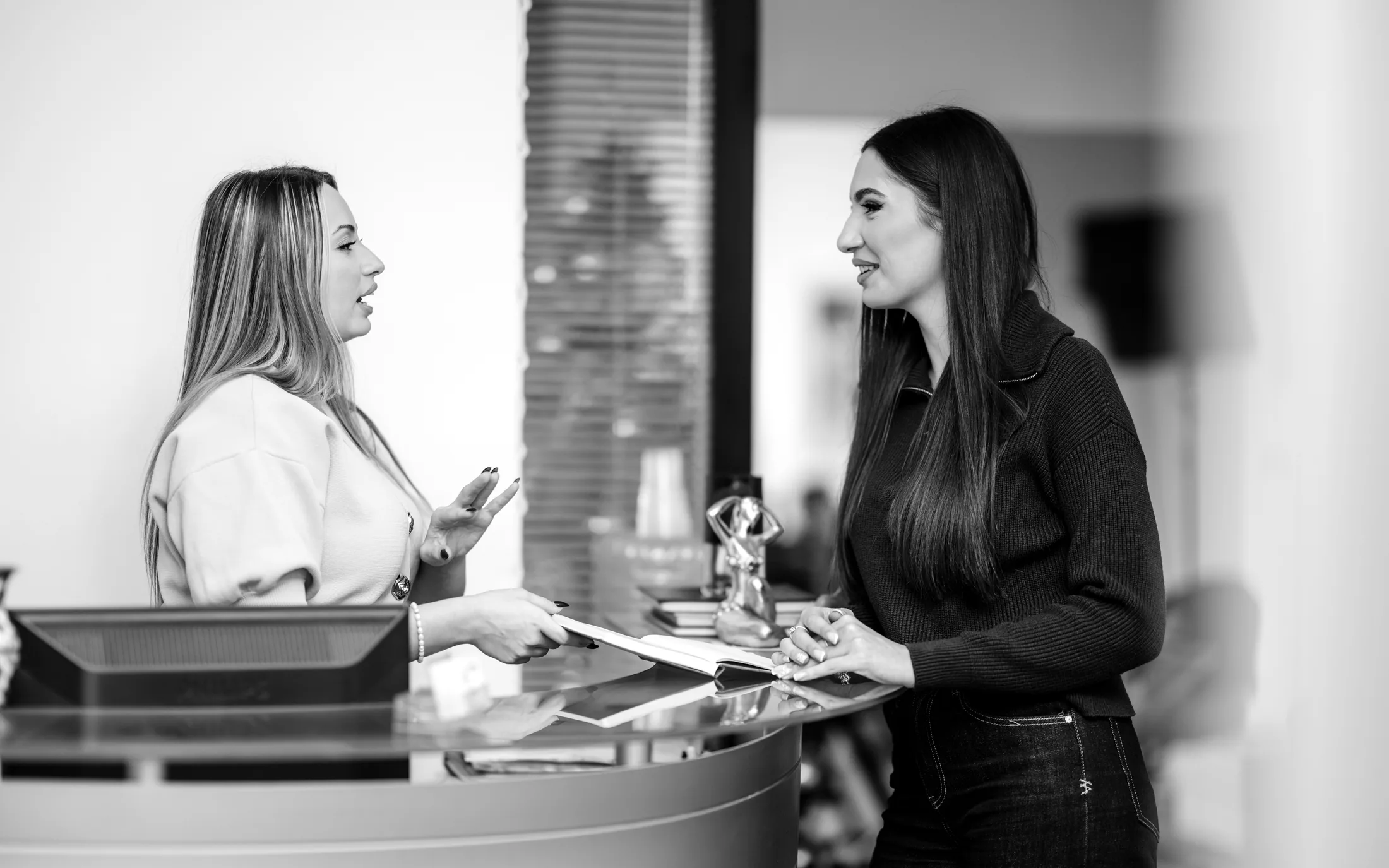Black-and-white front desk receptionist at a dental practice